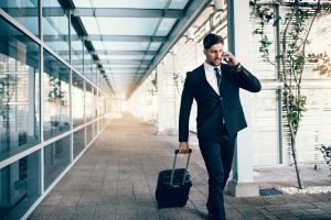 Businessman walking through airport during a short-term travel stay