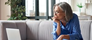 senior woman reading from laptop