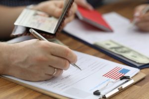 woman filling out visa and immigration paperwork